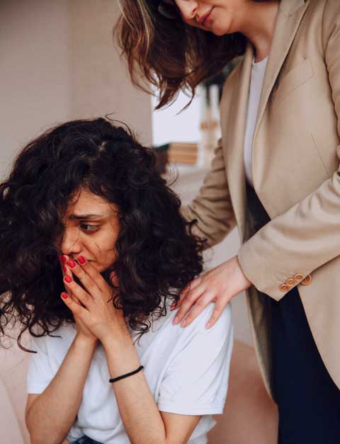 Woman comforting another woman