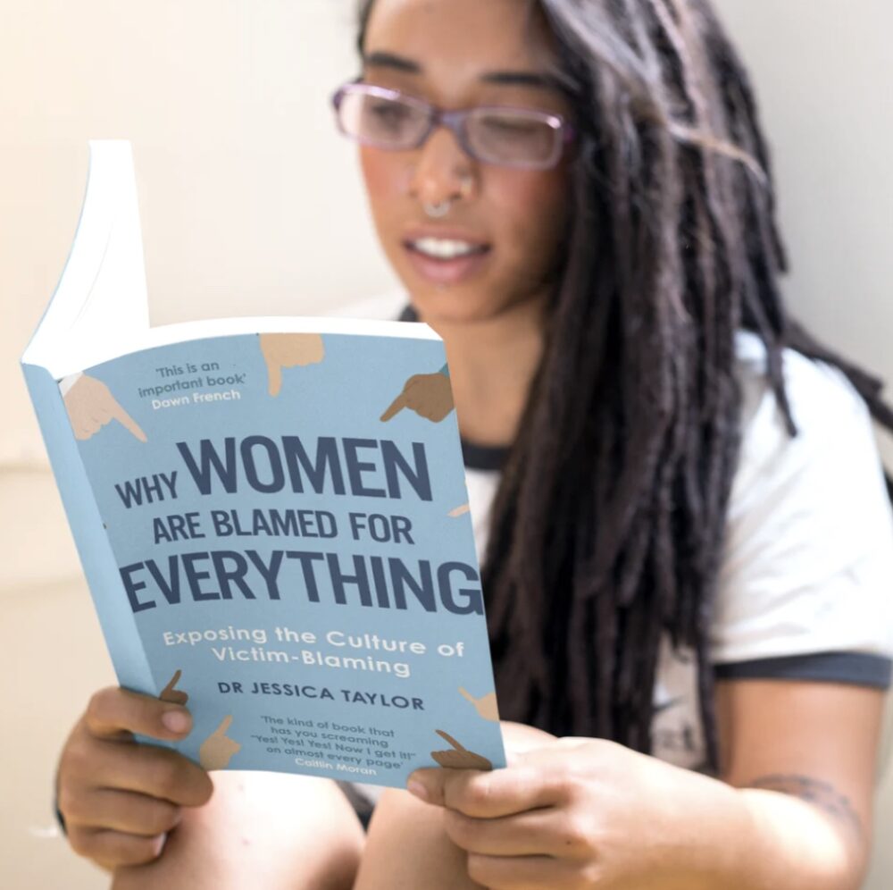 Woman reading Dr Jessica Taylor's book Why Women are Blamed for Everything: Exposing The Culture of Victim Blaming